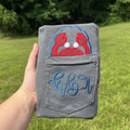 Gray Comfort Colors pocket t-shirt featuring a red crab applique peeking above the pocket with a personalized embroidered monogram stitched across the pocket, coastal beach-themed apparel.
