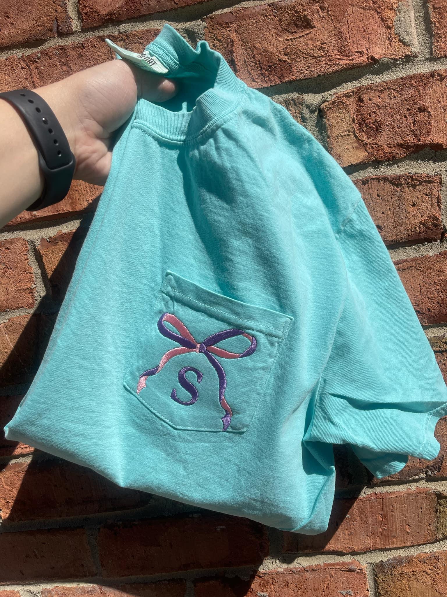 Two Tone Bow with Letter Embroidered Comfort Color Pocket Tee - Merch Girls