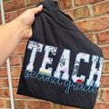 Personalized teacher appliqué shirt featuring TEACH fabric lettering with custom embroidered name underneath and customizable shirt and thread colors.