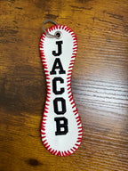 Keychain with 'Judaica' text on a wooden surface