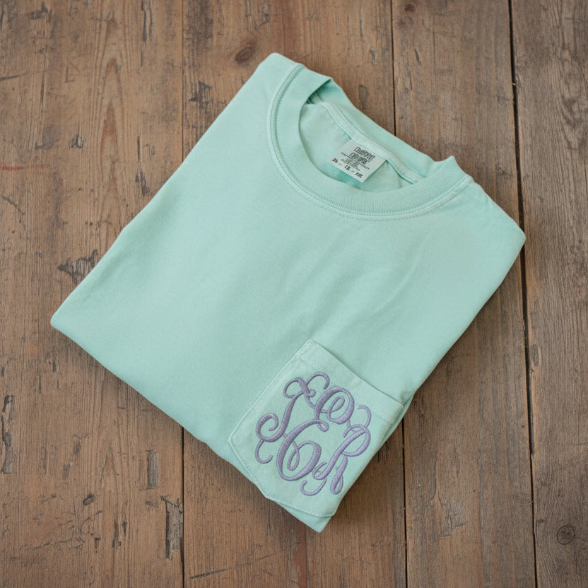 Personalized Comfort Colors pocket tee with lavender embroidered monogram on mint green shirt.